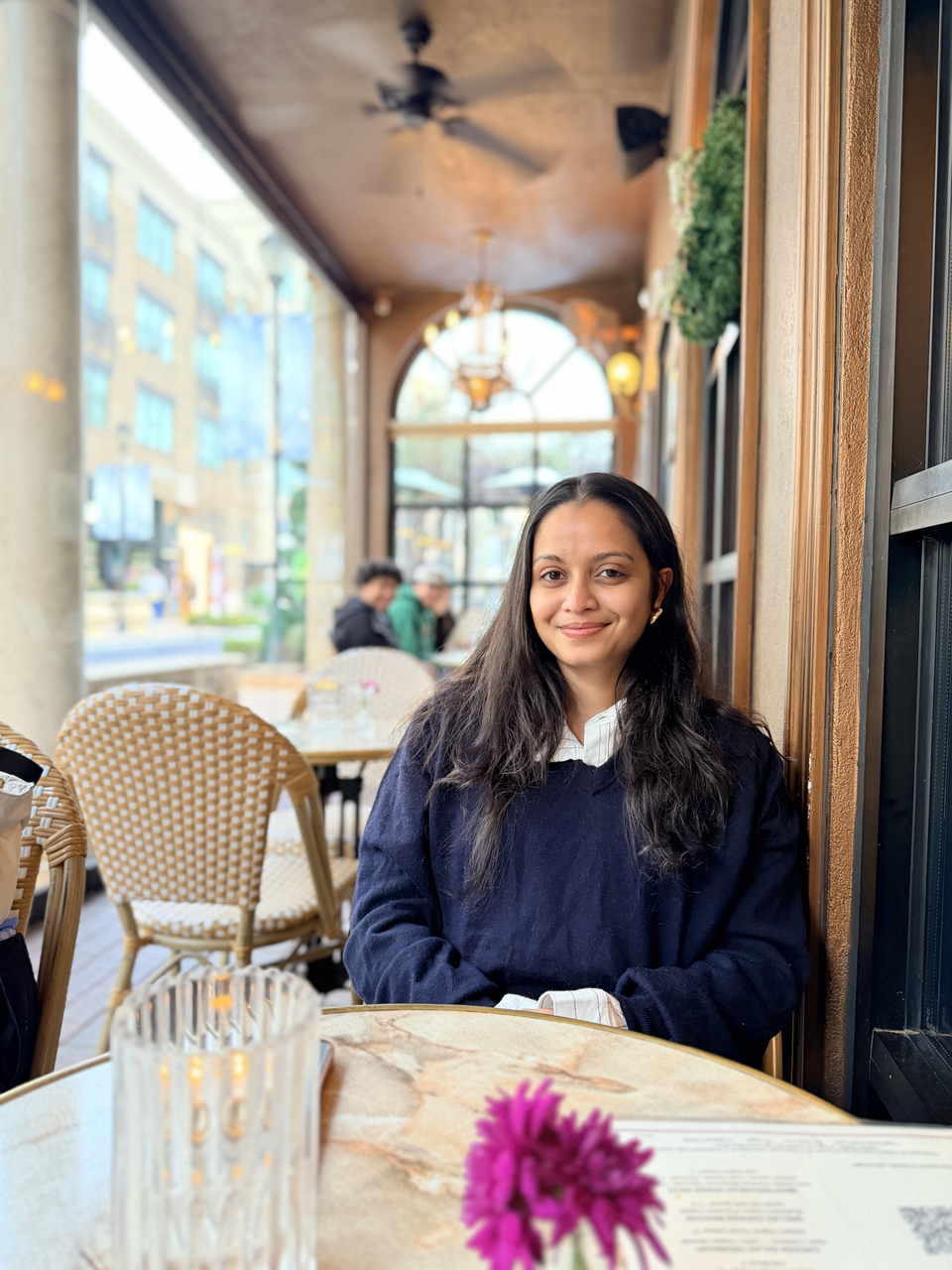 Khushbu Patel sitting at a round table in an elegant room