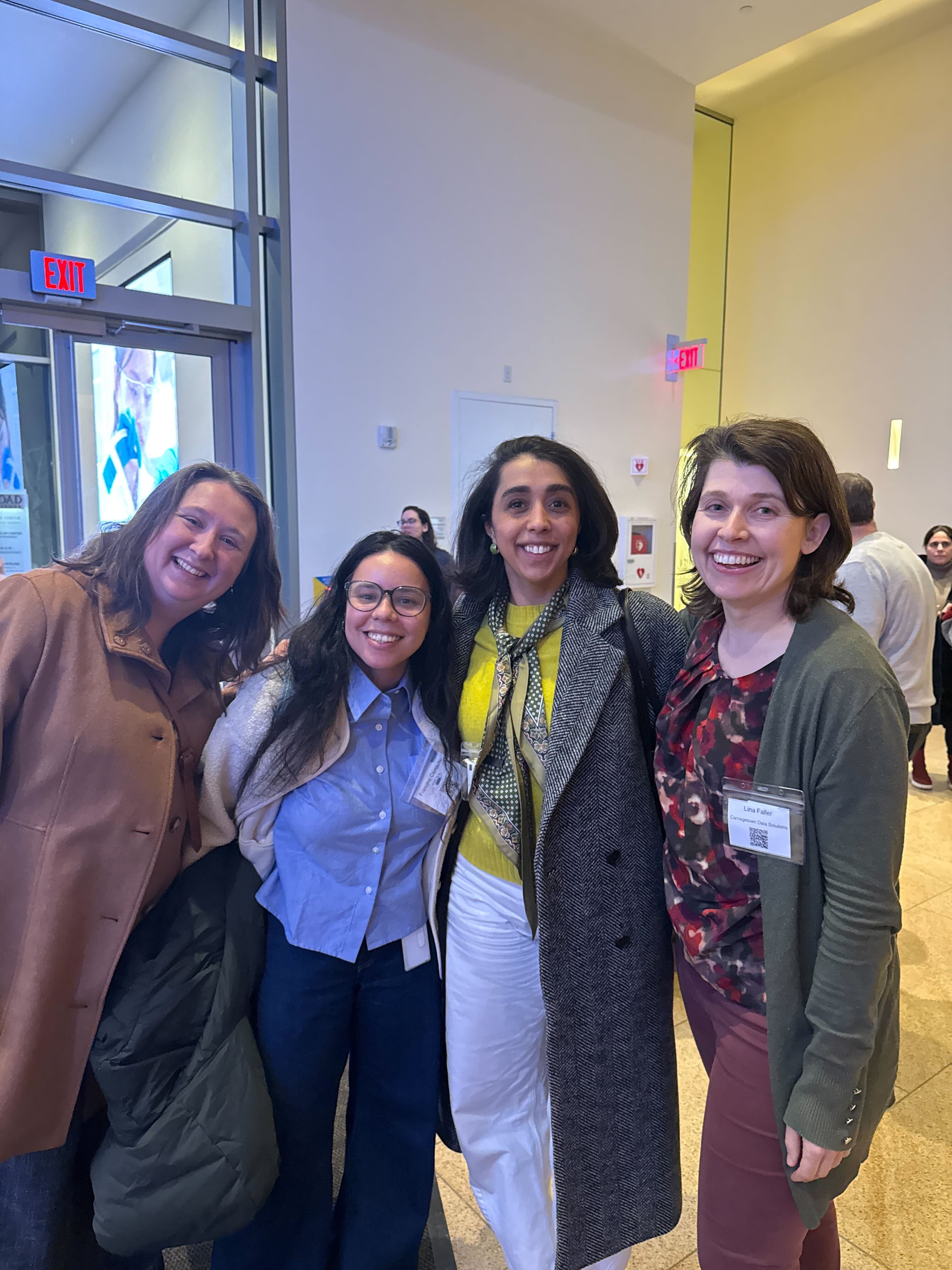 A group of Boston Women in Bioinformatics members gathered together at a community AI event.