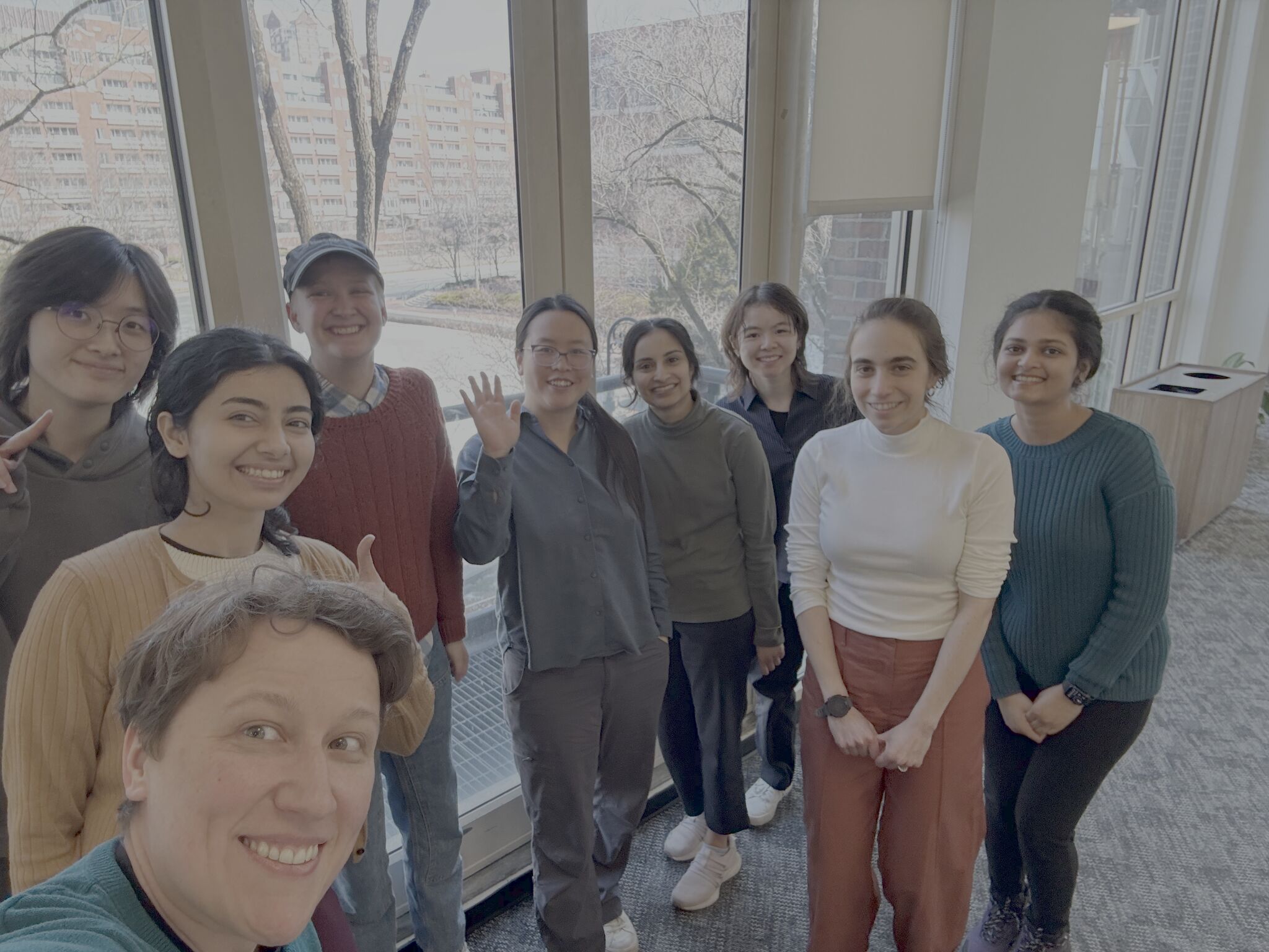 Nine nf-core Hackathon attendees pose for a selfie-style group photo, with the Seqera representative holding the camera.